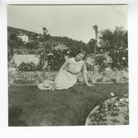 photographie de Daisy Weber, assise dans l’herbe, dans le jardin de la villa de Saint-Clair, été 1913