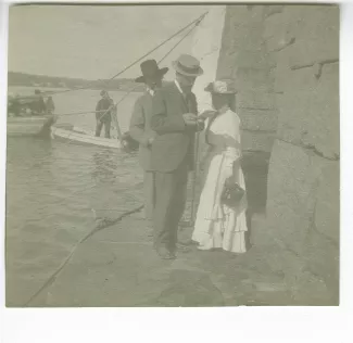 photographie montrant André Gide, avec moustache et chapeau, Henri Ghéon et Maria Van Rysselberghe, sur un débarcadère, août-septembre 1907