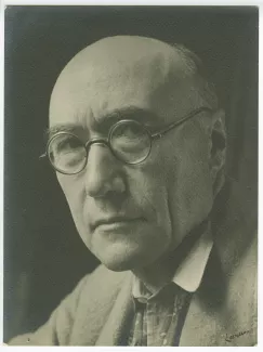 portrait photographique en gros plan d’André Gide, avec lunettes et foulard fleuri, de ¾ à gauche, regardant l’objectif, au Vaneau