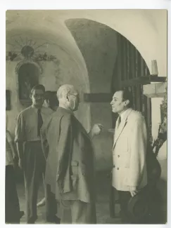 photographie d’André Gide, avec lunettes, Antonio Aniante lui faisant face, derrière eux Alfredo Quaglino (cravate) et une autre personne, à La Colombe d'or, juin 1949