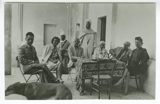 photographie montrant André Gide (deuxième à droite), avec lunettes, Maria Van Rysselberghe à sa droite, Marcelle Schveitzer (l'une des deux autres femmes) et d'autres personnes, attablées, mars-avril 1945