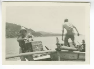photographie de Miss Todd [?], déchargeant un bagage d'une barque, juillet 1931